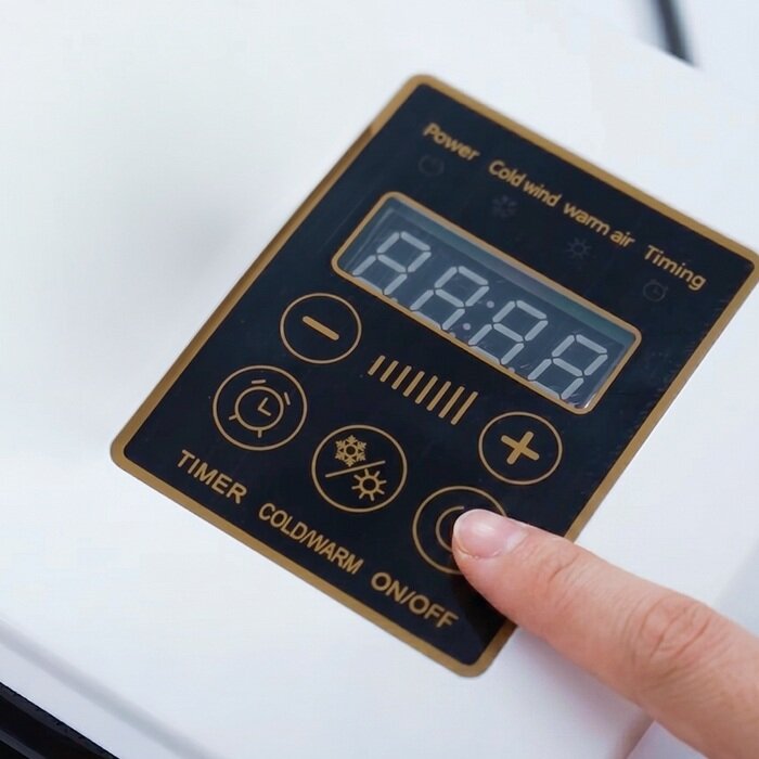 A hand selecting a setting on the BlizzAir remote control